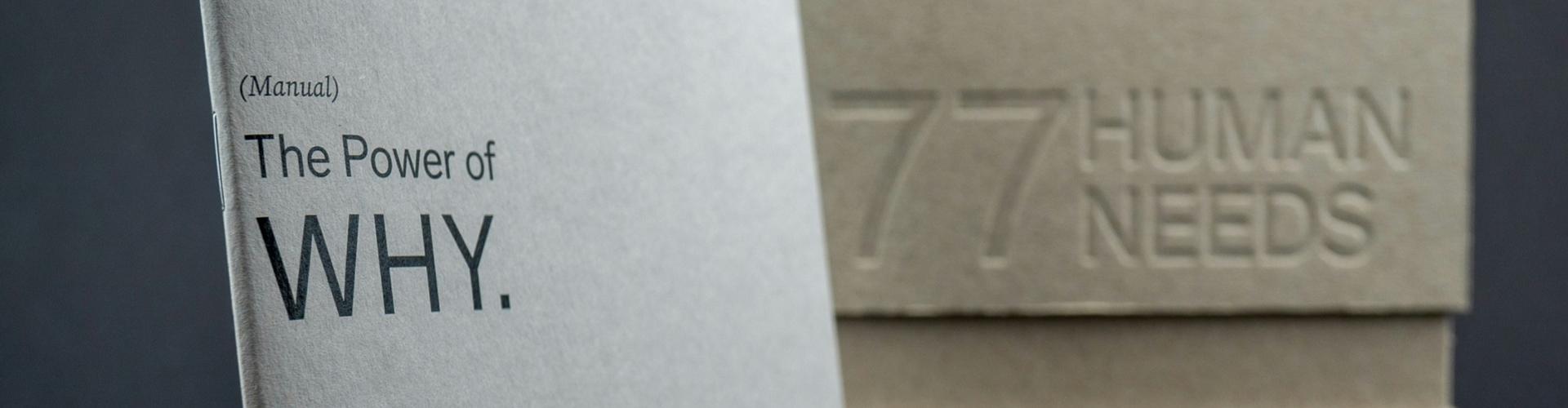 Image of a book with the title "The Power of WHY" on the left page and "77 Human Needs" on the right page