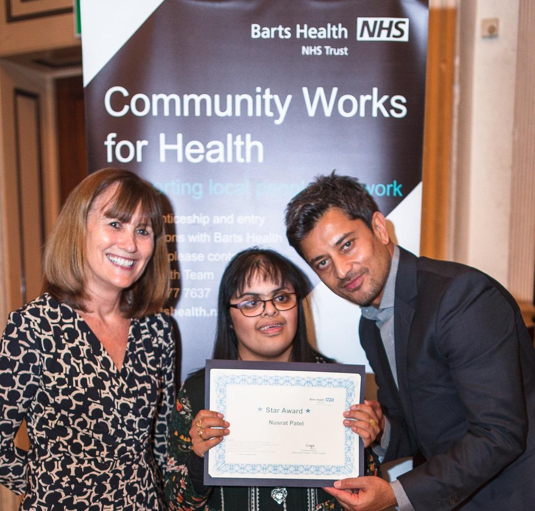 Nusrat Patel receiving her award at Community Works for Health