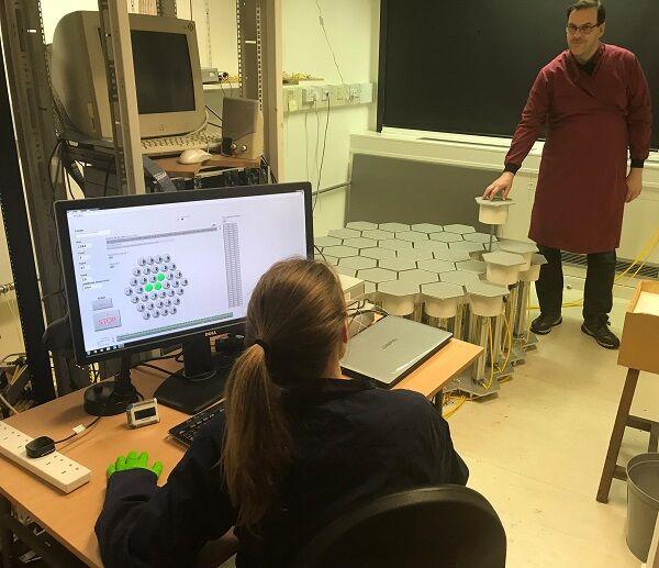 Researchers with the honeycomb maze and computer interface
