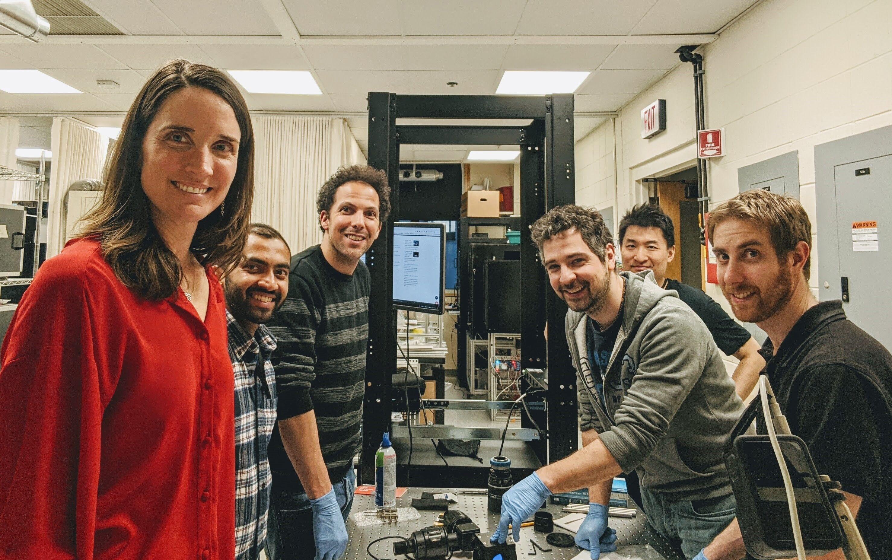 Dr Anne Churchland and lab in front of experimental rig