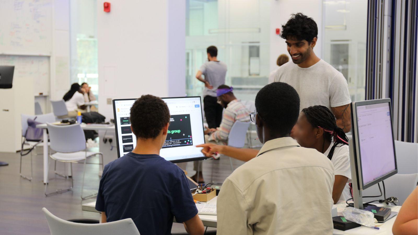 Jai Bhagat teaching three Neuronauts summer school students at SWC