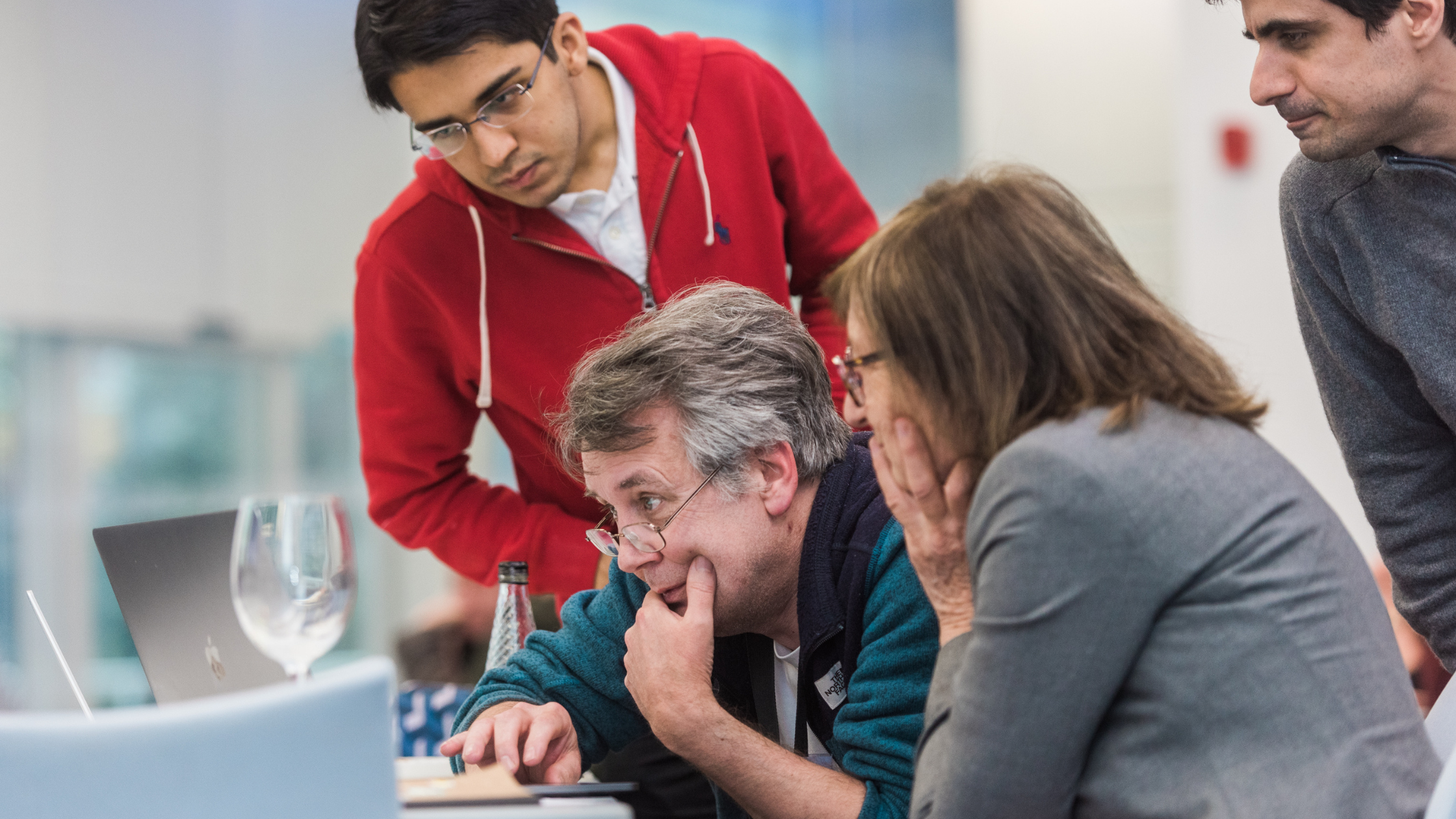 Teachers and students gathered around PC