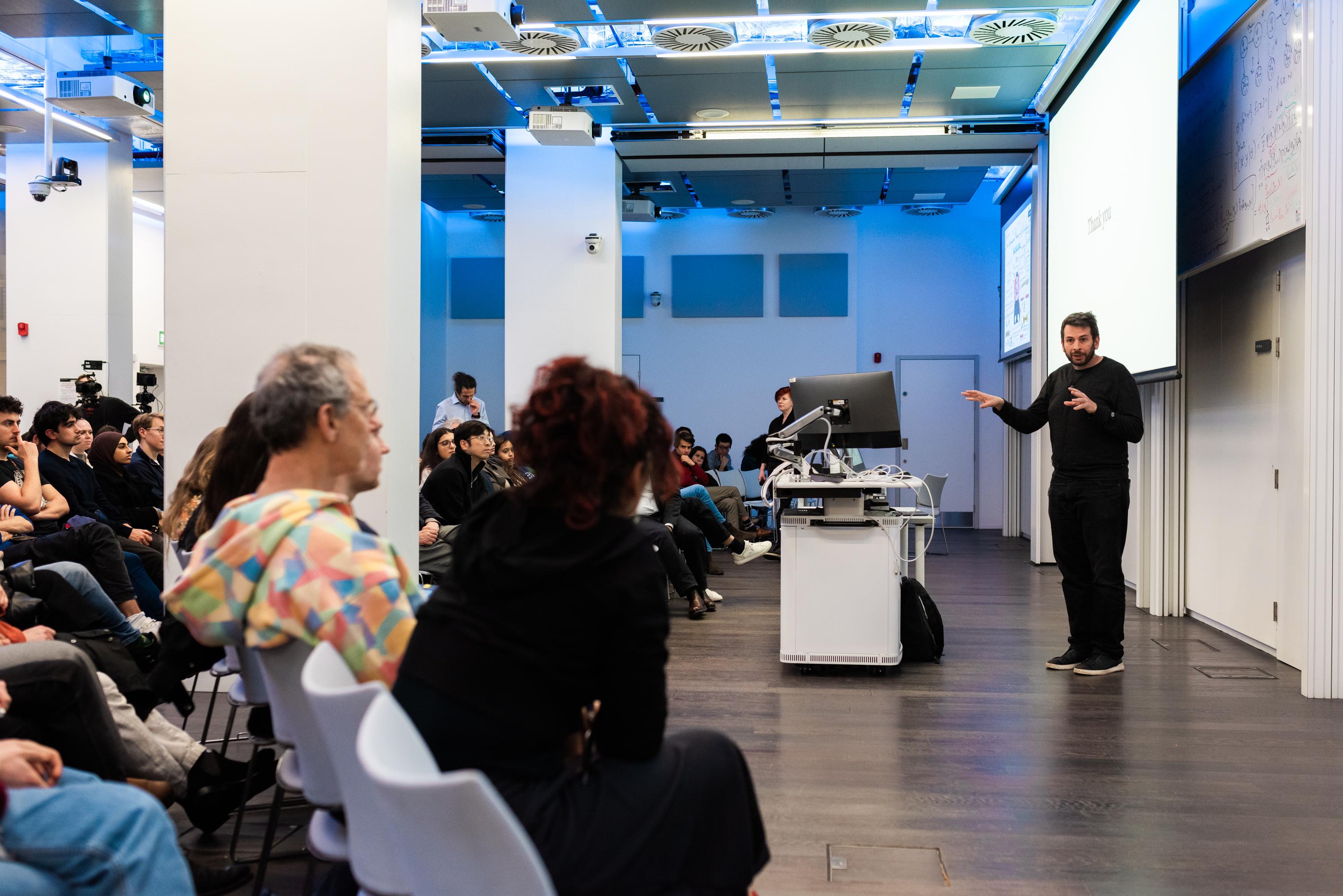 Blaise Agüera y Arcas answering questions from the audience following the SWC Lecture 2024. Photo by James Tye.