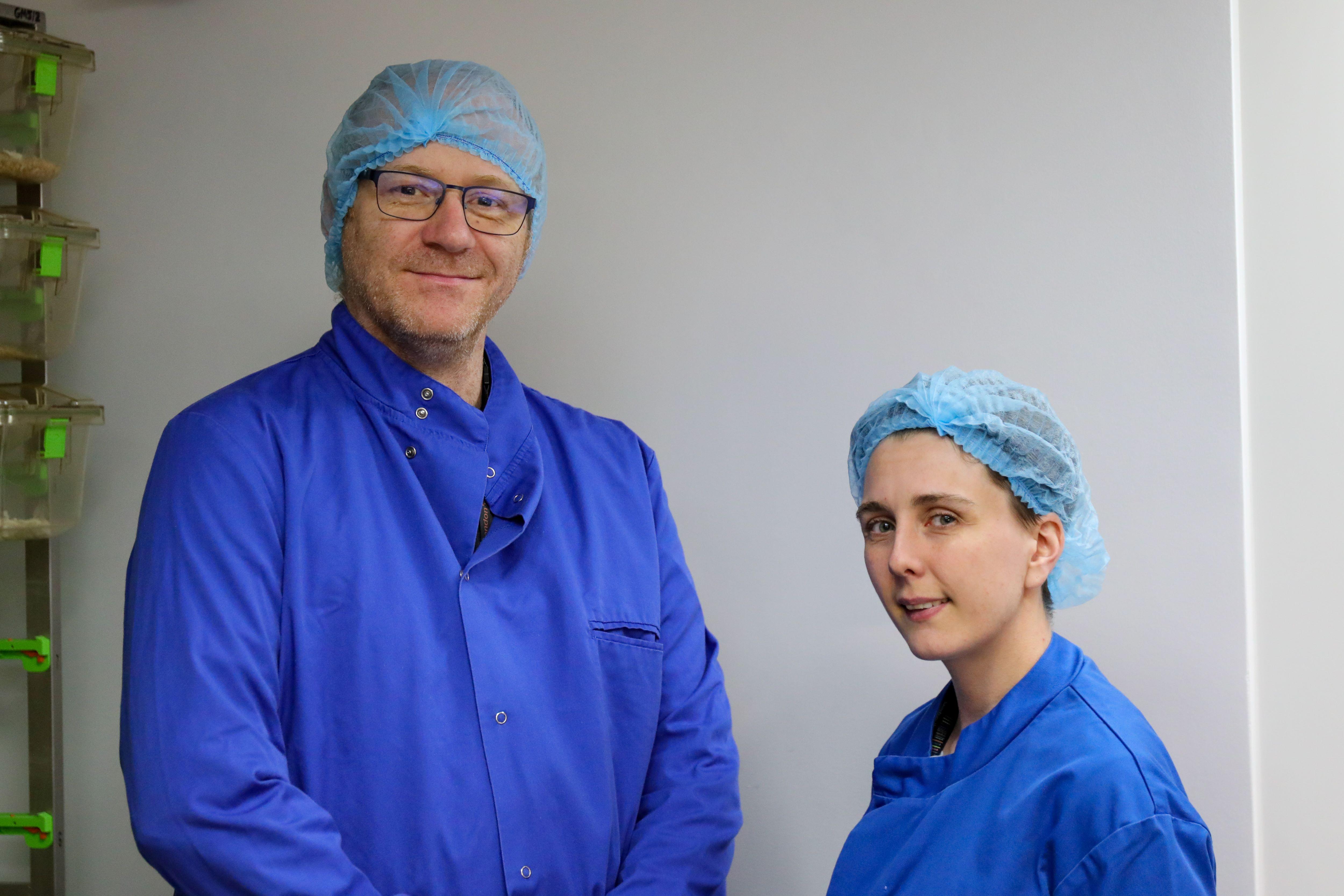 Photo of Christophe Galichet and Amy Veness in blue lab coats