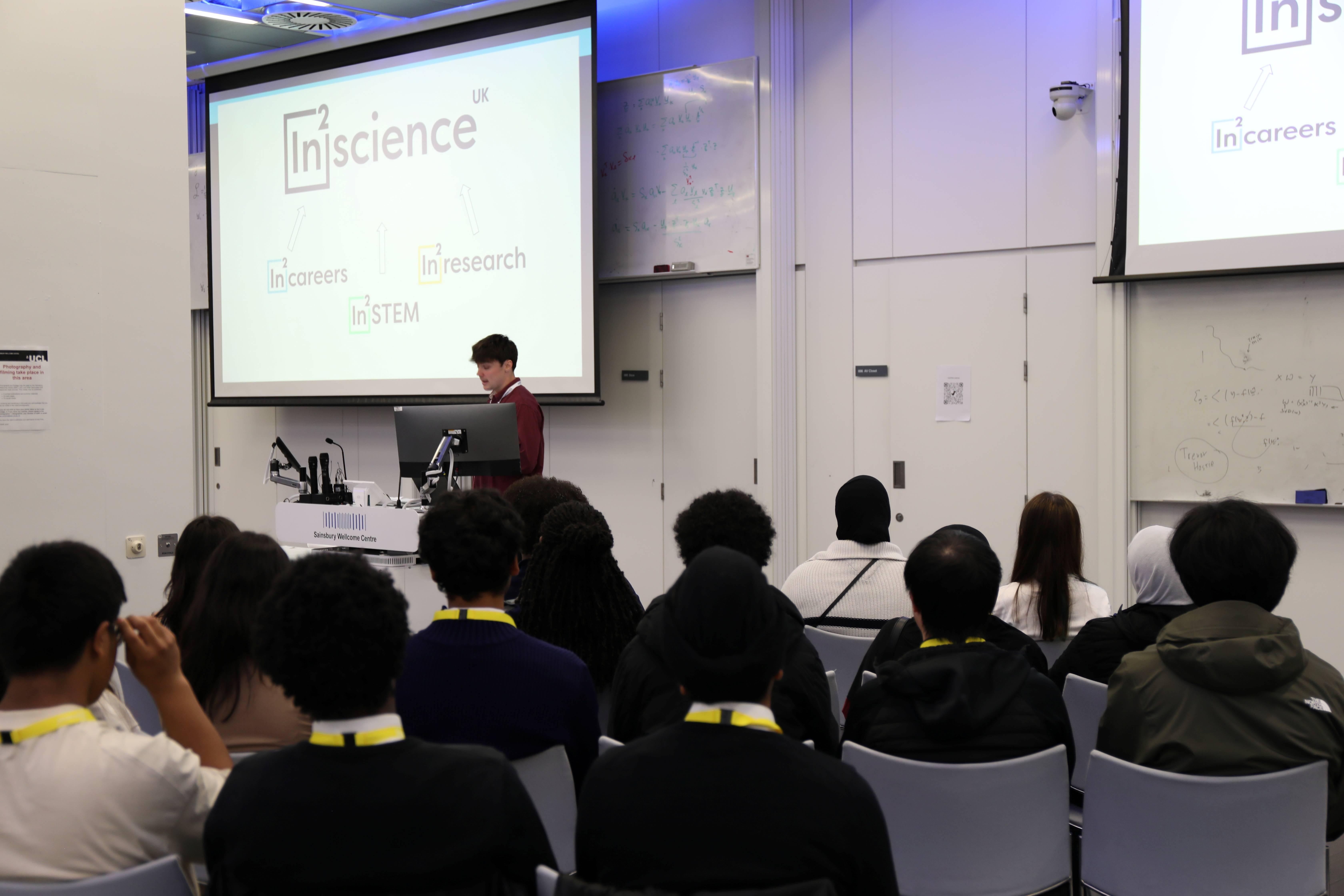 Photo of In2STEM students listening to an opening talk during the London induction
