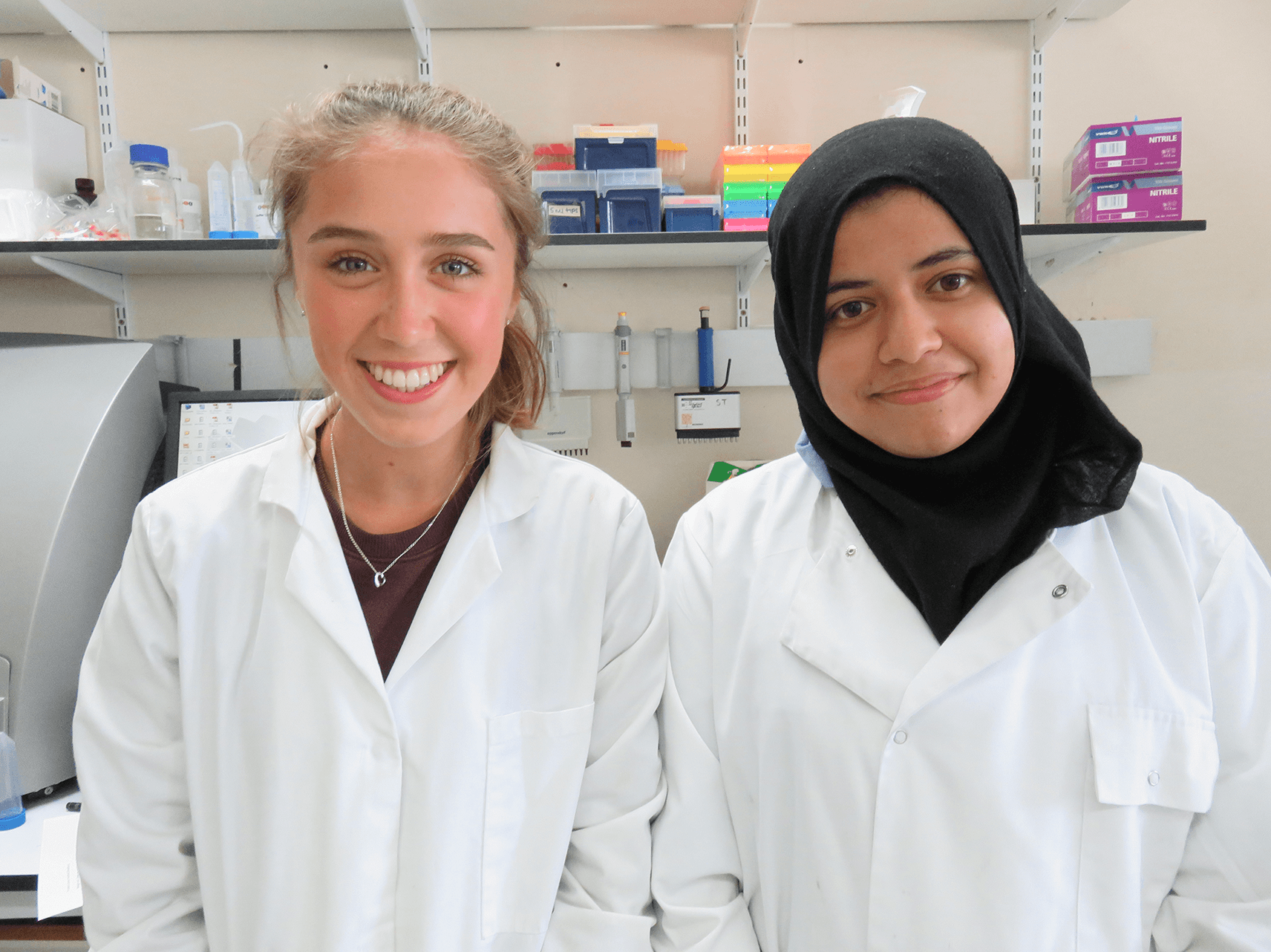 Two In2research students in lab coats
