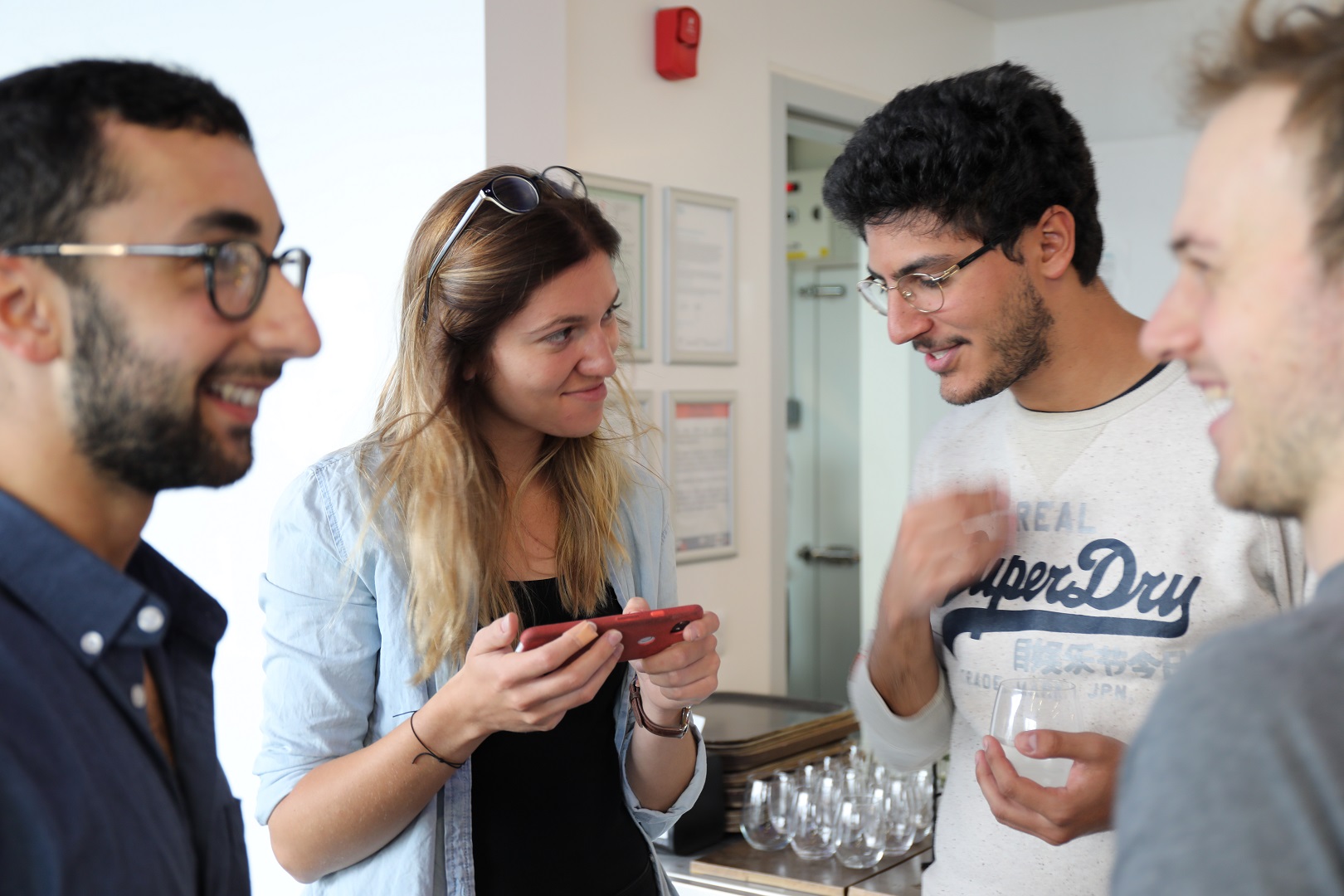 Photo of Gatsby and SWC PhD students talking at a Centre event