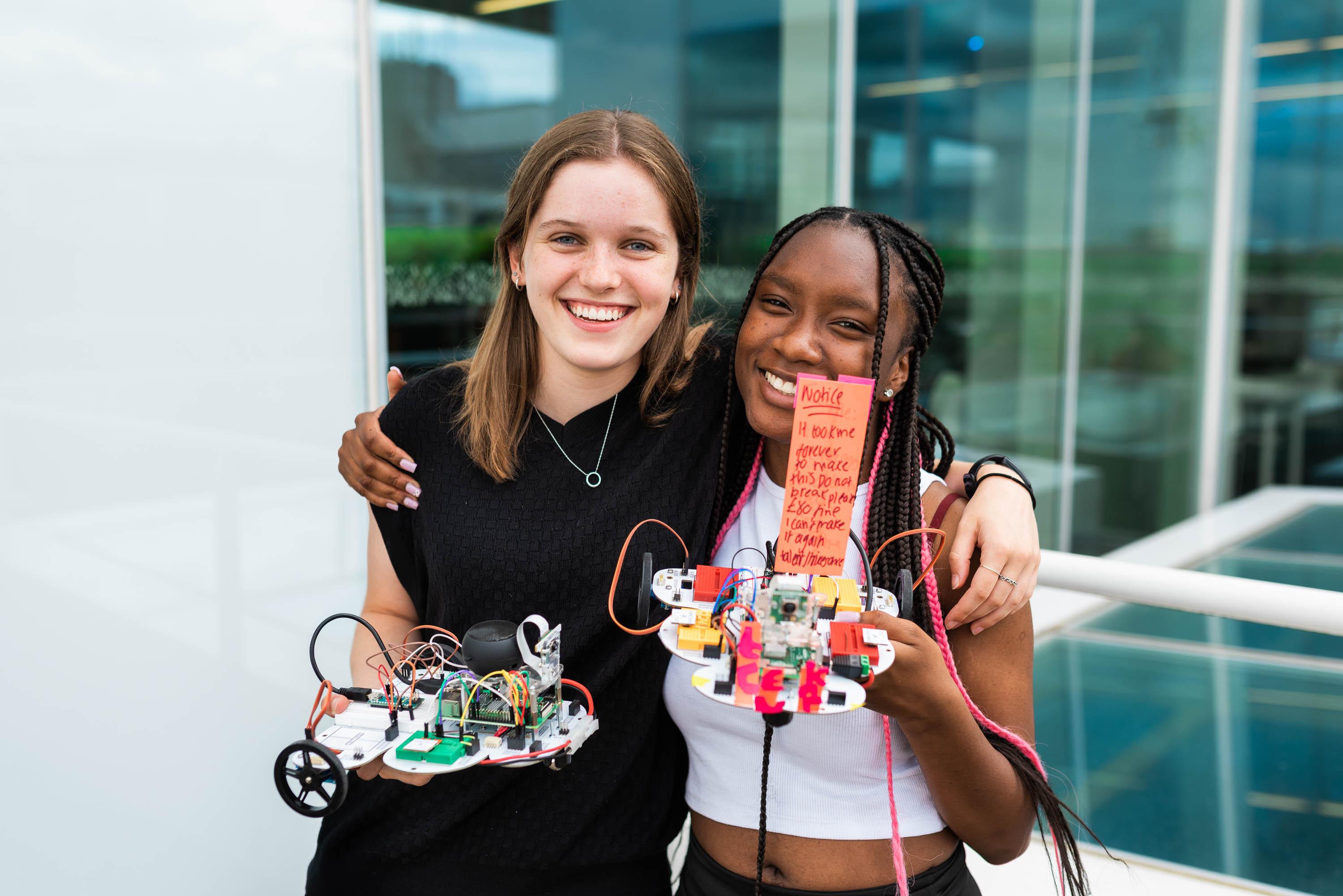Too Neuronauts 2023 students holding their robots