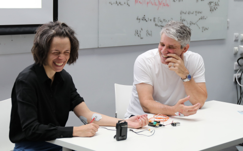 Photo of scientists at SWC demonstrating the Human-Human interface to students